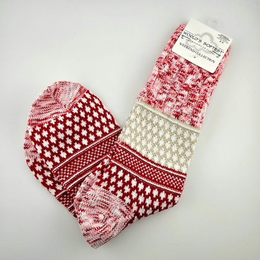 Pair of red and white patterned socks on a gray background