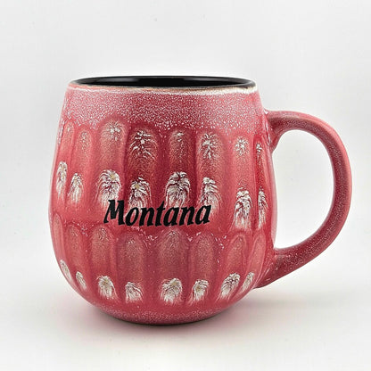 Red mug with 'Montana' text and horse design on a white background