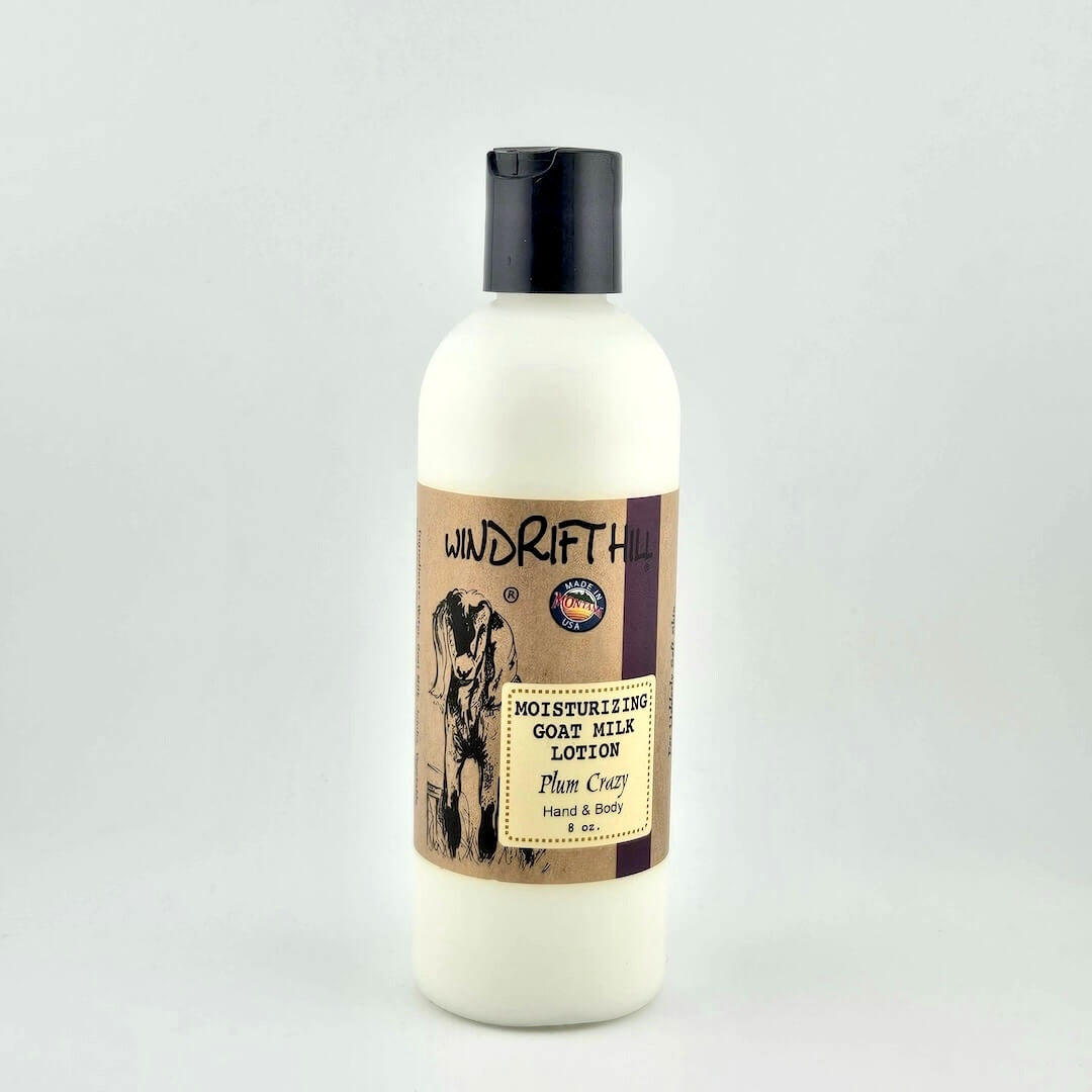 Plastic bottle of Windrift Hill moisturizing goat milk lotion on a gray background