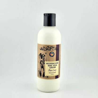 Plastic bottle of Windrift Hill moisturizing goat milk lotion on a gray background