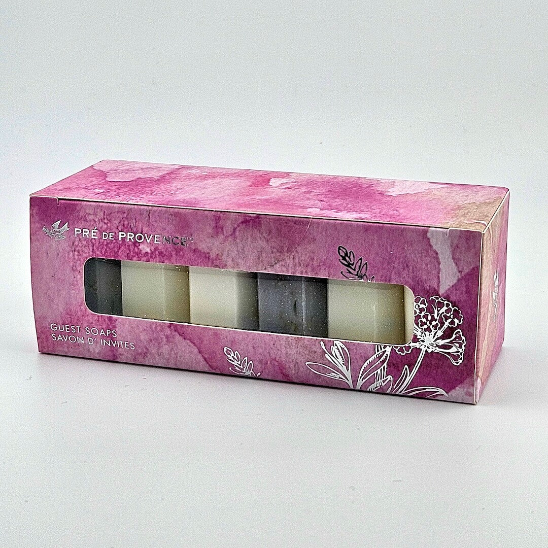 Pink packaging box with three soaps inside on a white background
