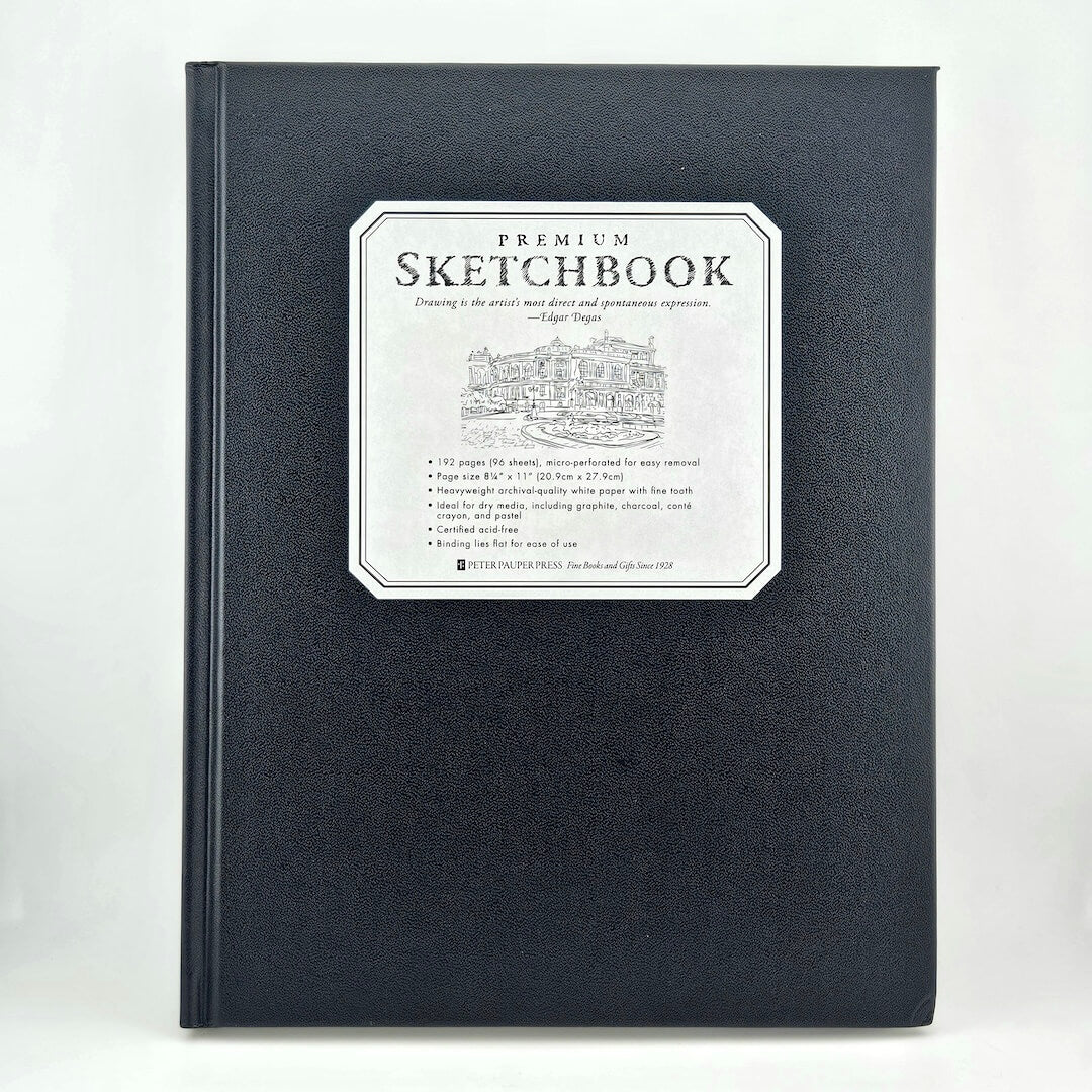 Black sketchbook with a white label on a white background