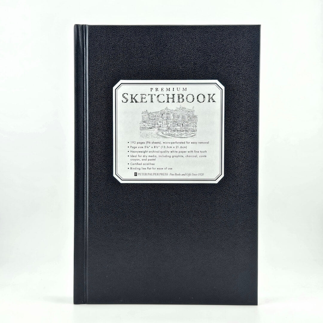 Black sketchbook with a label on a white background