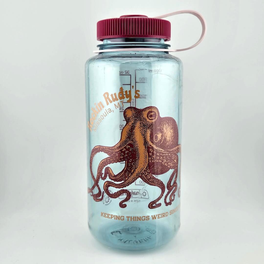 Light blue water bottle with magenta lid and image of magenta/orange octopus below, "Rockin Rudy's, Missoula, MT." 