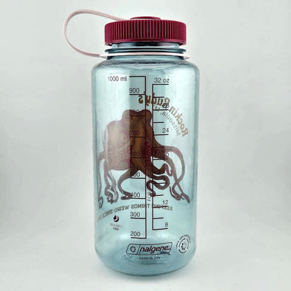 Light blue water bottle with magenta lid and mL & oz measurements identified in magneta ink. 
