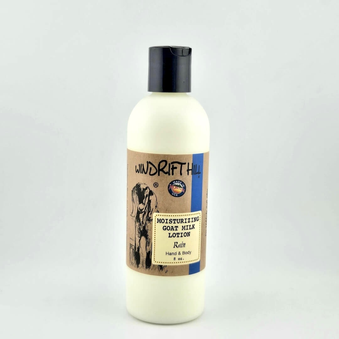 Plastic bottle of Windrift Hill moisturizing goat milk lotion on a gray background