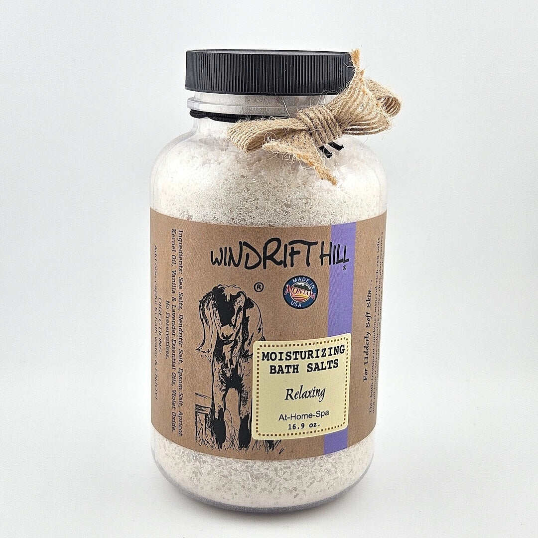 Jar of Windrift Hill bath salts with a decorative ribbon on a gray background