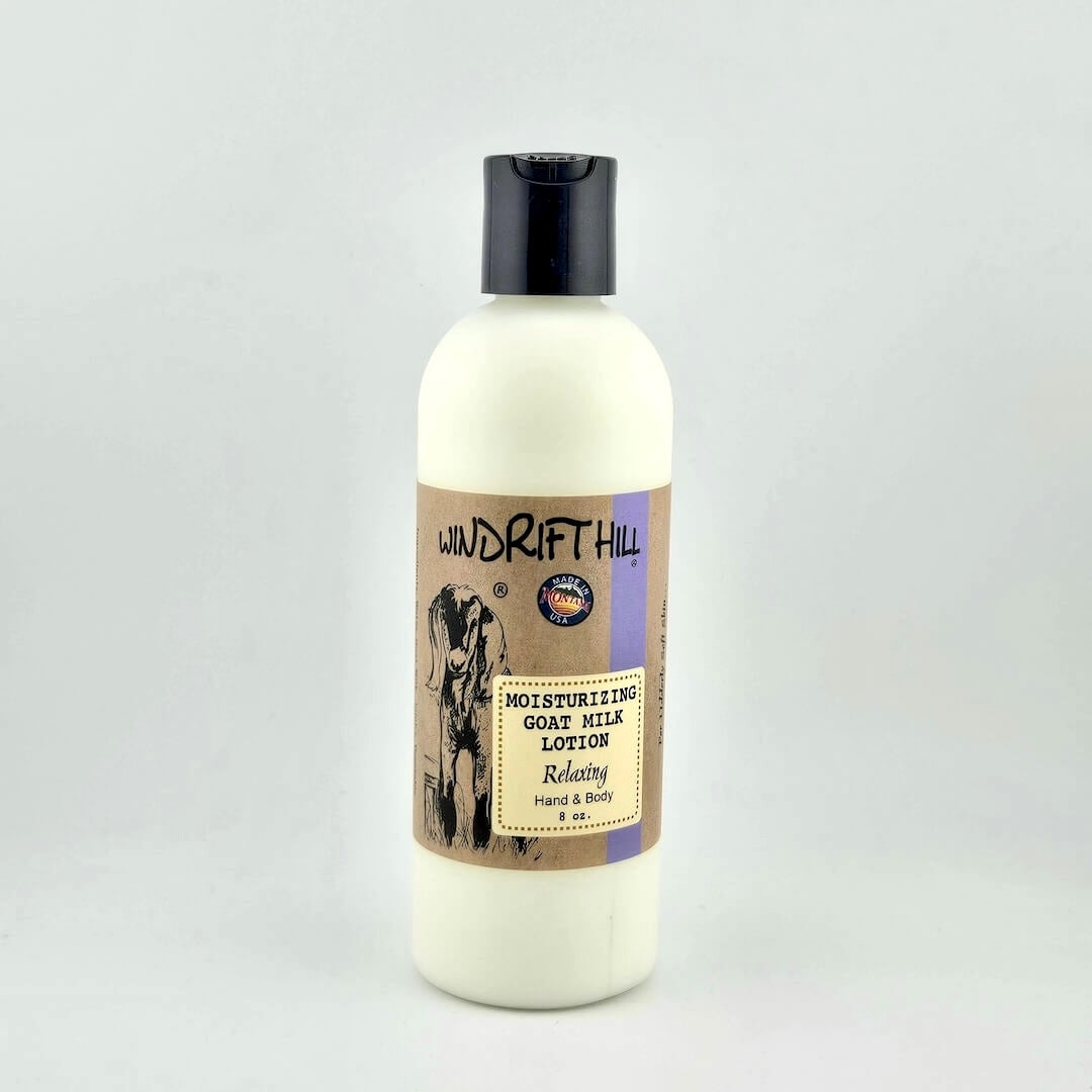 Plastic bottle of Windrift Hill moisturizing goat milk lotion on a gray background