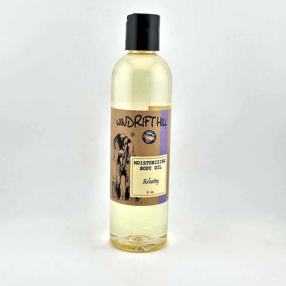 Plastic bottle of Windrift Hill moisturizing body oil on a gray background