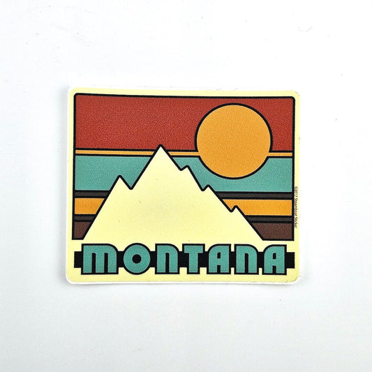 Sticker with mountain and sun design with 'Montana' text on a white background