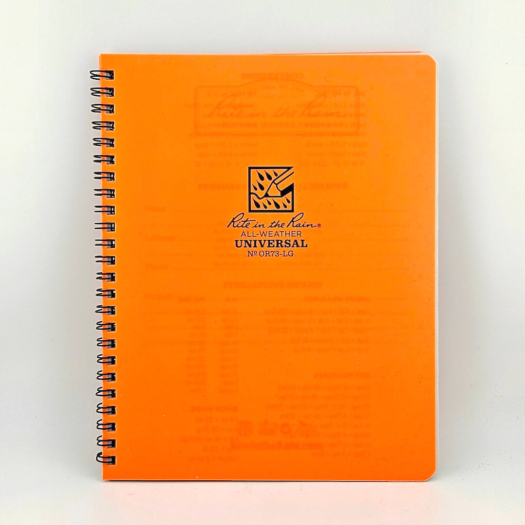 Orange notebook with spiral binding on a white background