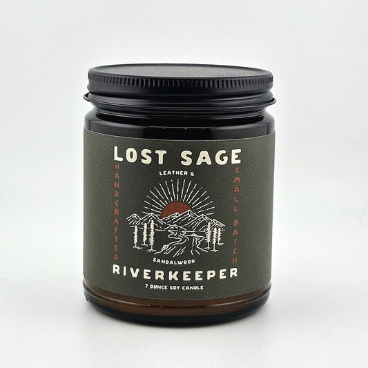 Candle jar labeled 'Lost Sage Riverkeeper' on a white background