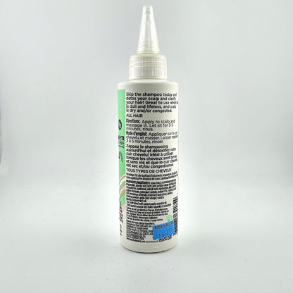 Backside of haircare bottle with product information in black text. 