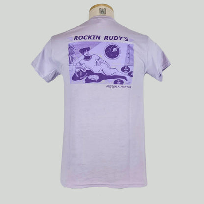 Lavender t-shirt with girl in space suit laying down by cat and scattered records with porthole showing planet & stars. 