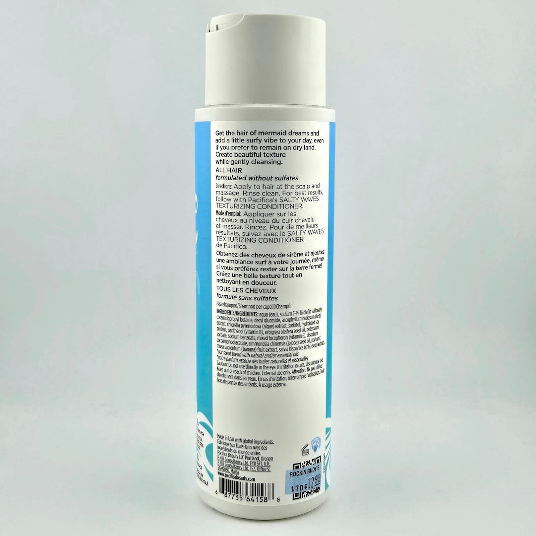 Bottle of shampoo with a label on a light gray background