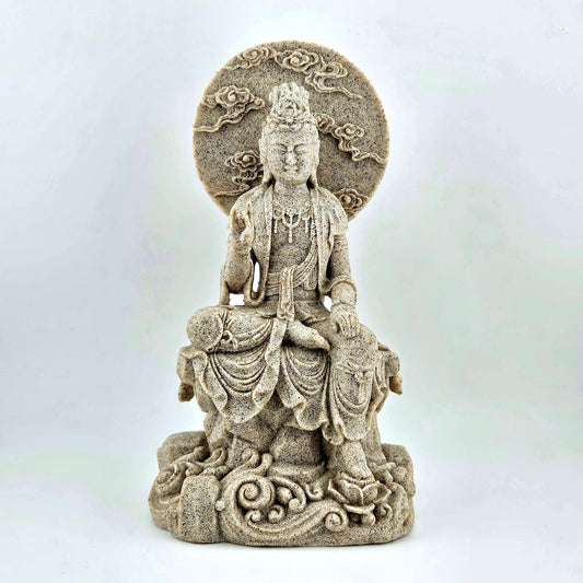 Statue of a seated figure with intricate details on a white background