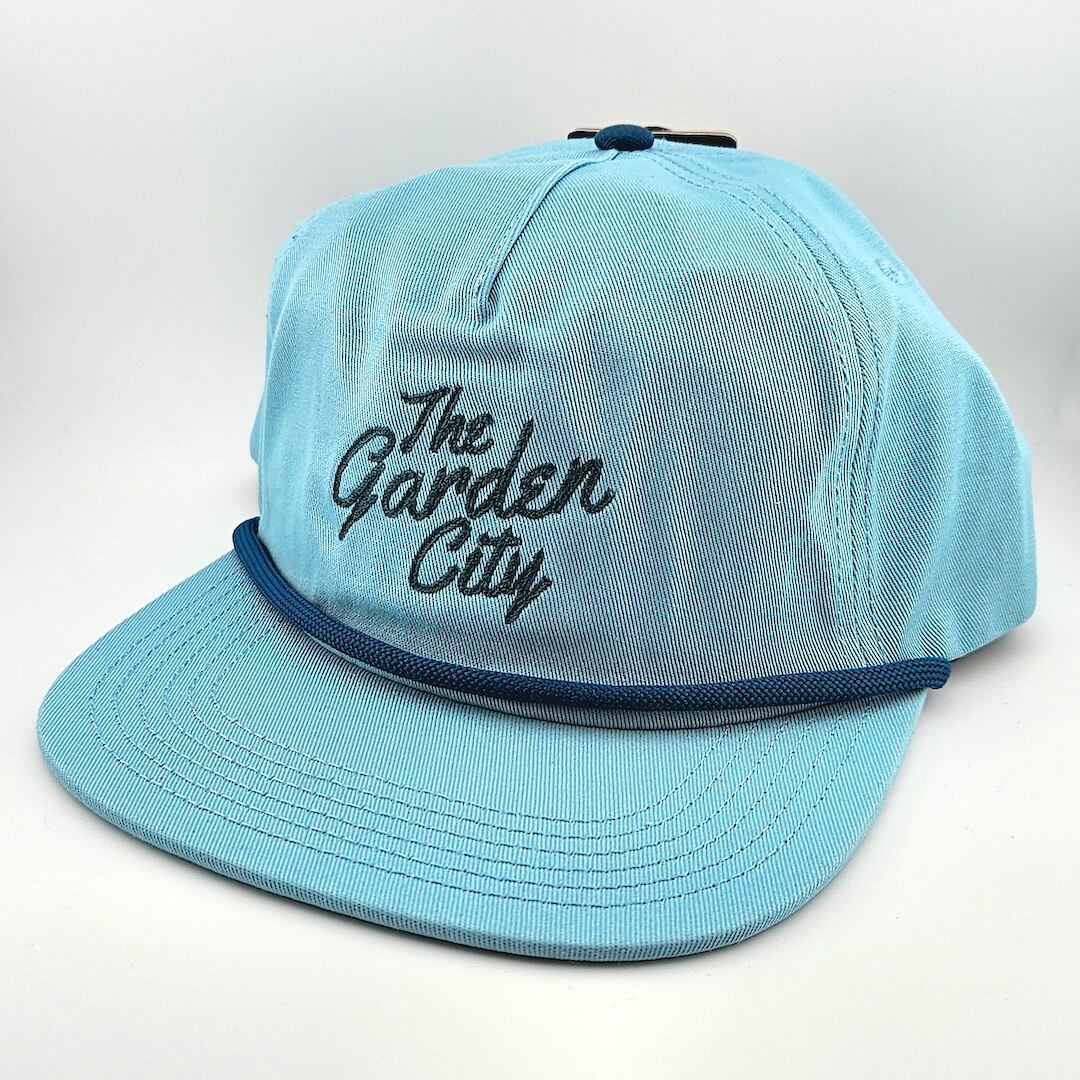 Light blue cap with 'The Garden City' text on a white background