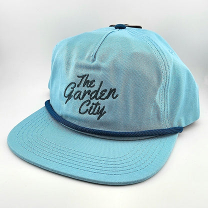 Light blue cap with 'The Garden City' text on a white background