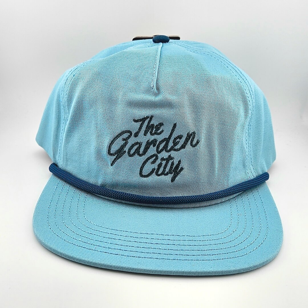 Light blue cap with 'The Garden City' text on a white background
