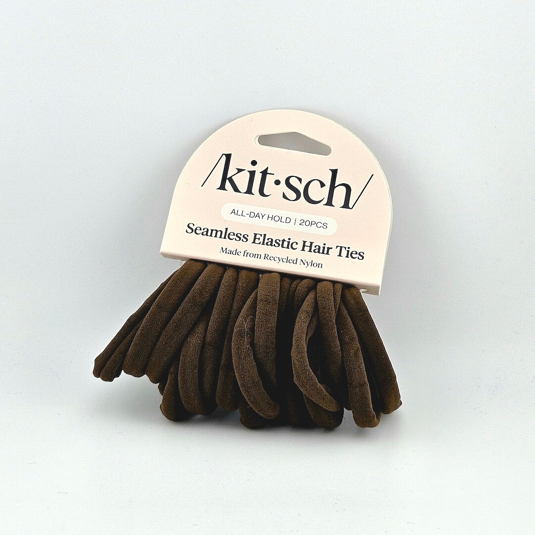 Brown hair ties with 'kitsch' packaging on a light gray background