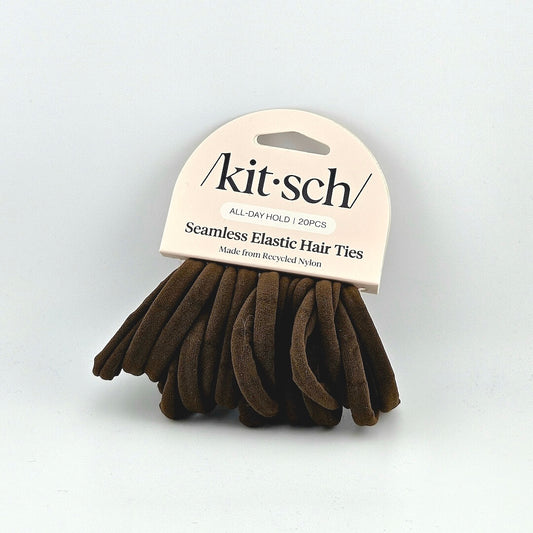 Brown hair ties with 'kitsch' packaging on a light gray background