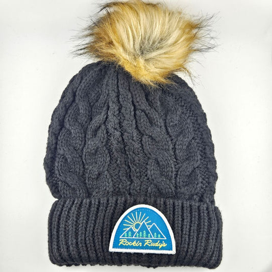 Black knit beanie with a pom-pom and a logo on a white background