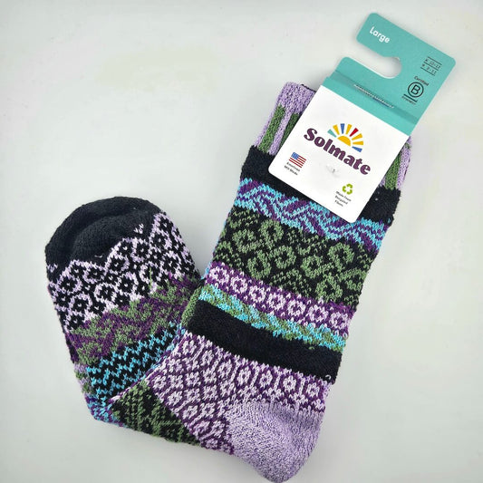 Pair of patterned socks with Solmate brand label on a light gray background