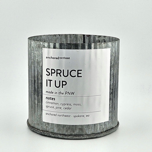 Candle in a metal container with a label on a white background