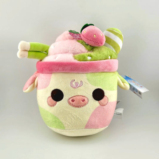 Plush toy resembling a character with a pink and green design on a light gray background