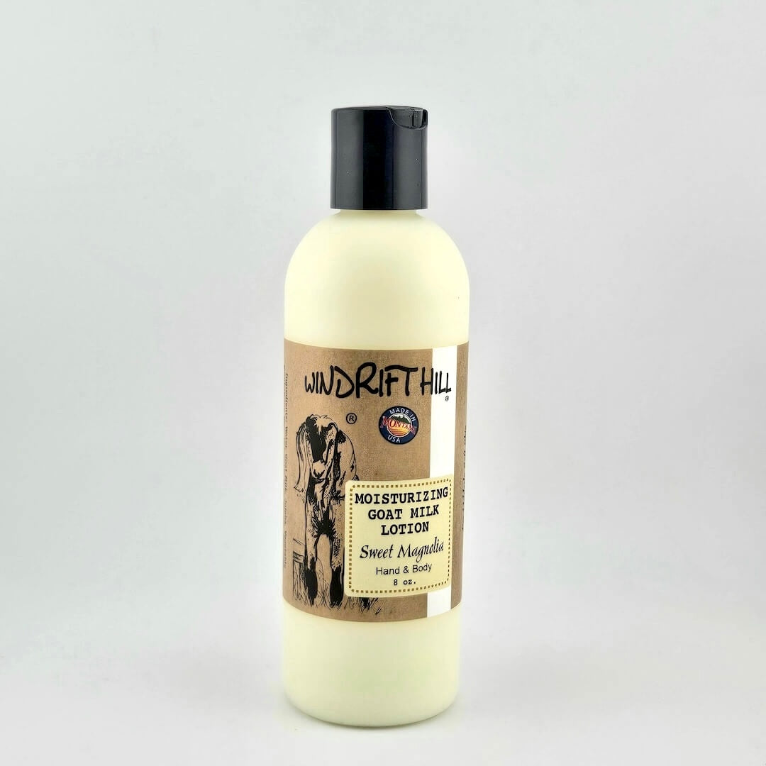 Plastic bottle of Windrift Hill moisturizing goat milk lotion on a gray background