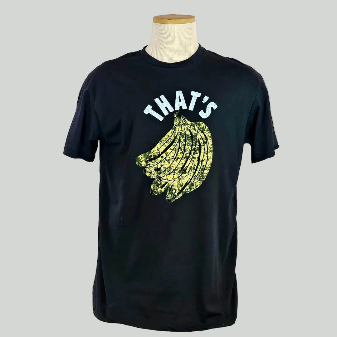 Black t-shirt with yellow banana graphic and 'THAT'S' text on a mannequin against a white background