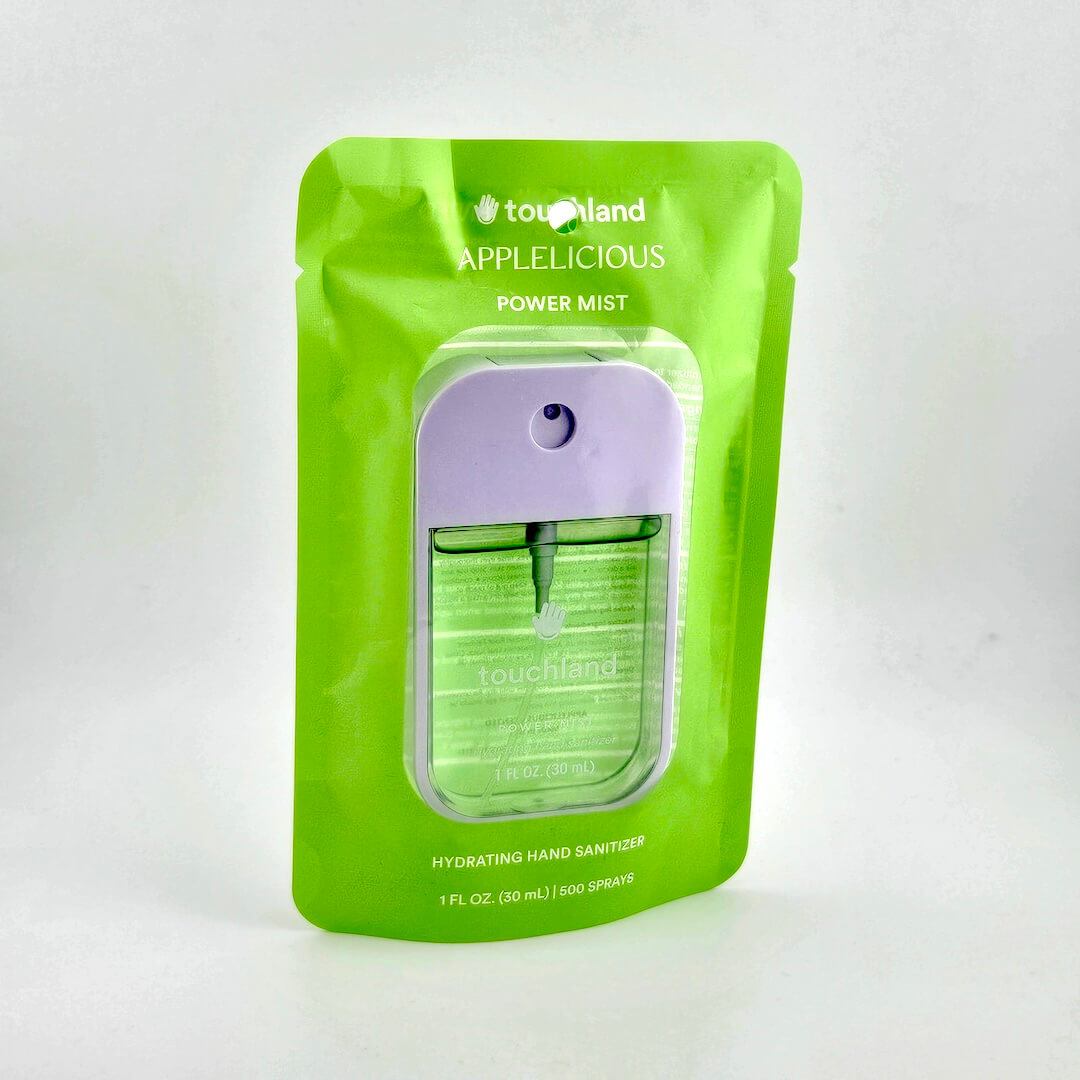 Green hand sanitizer package with purple cap on a white background