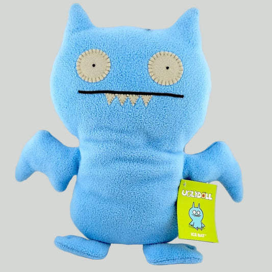 Blue plush toy with a yellow tag on a white background