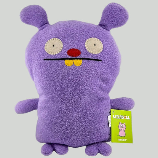 Purple plush toy with a smiling face on a white background
