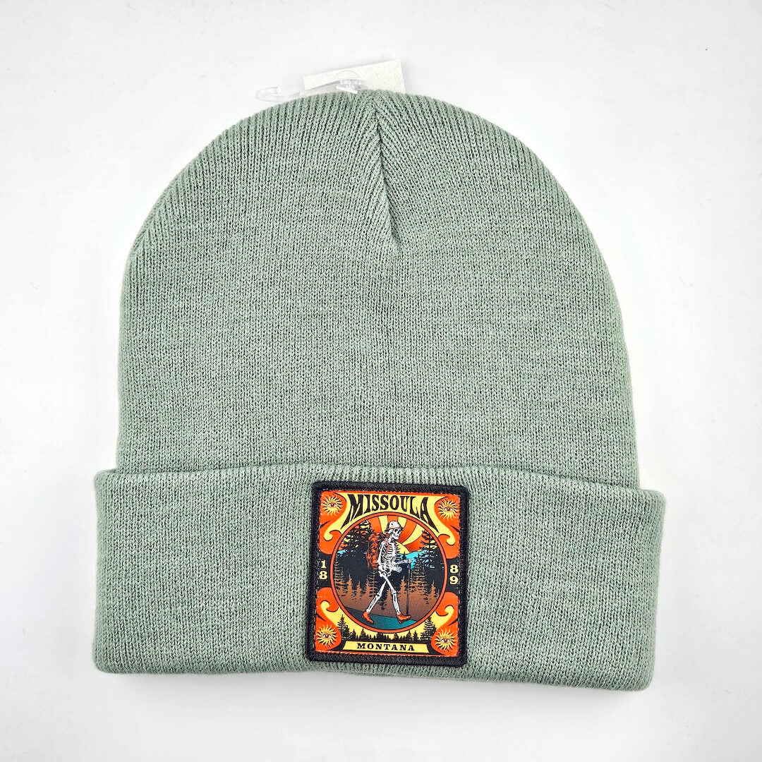 Green beanie with a patch on a white background