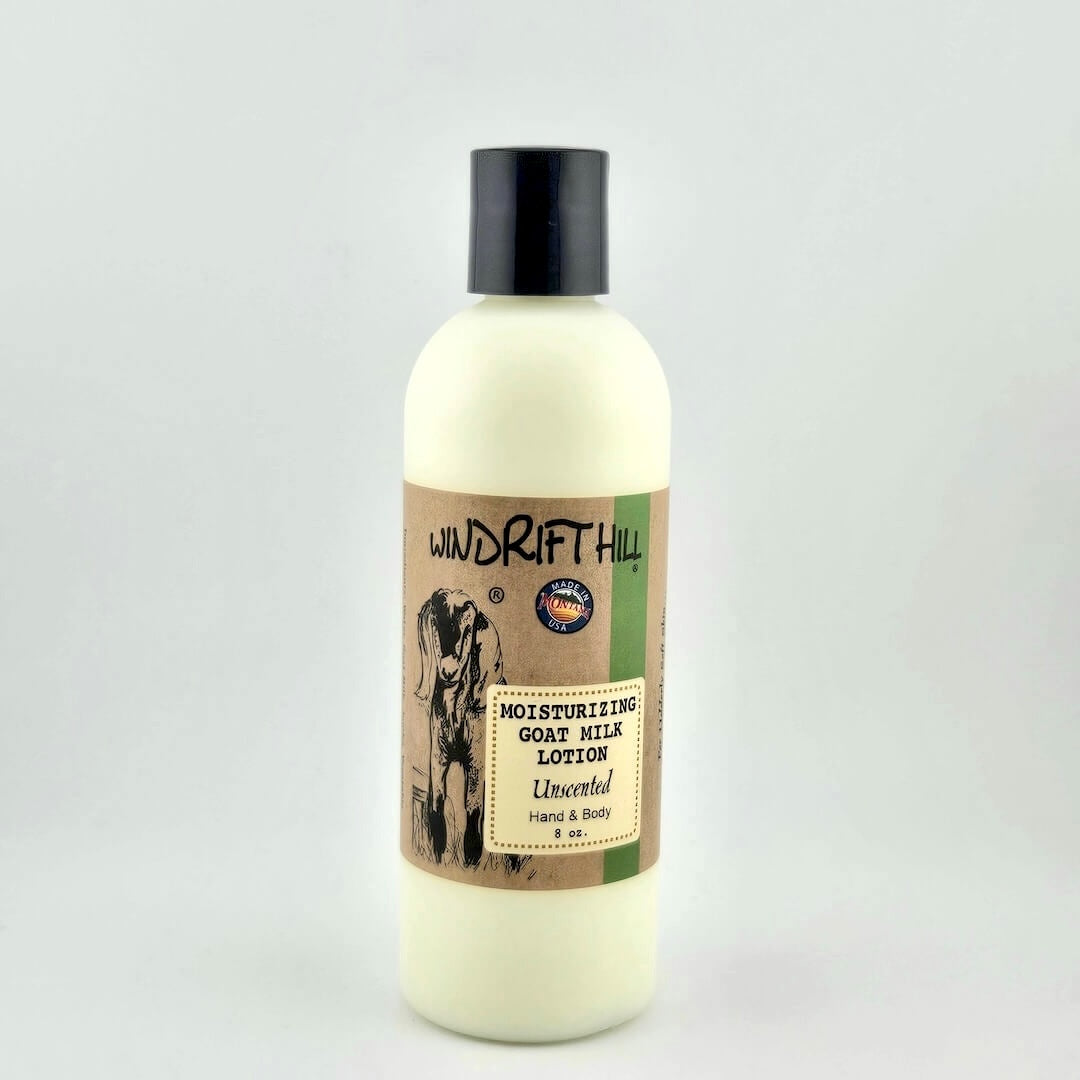 Plastic bottle of Windrift Hill moisturizing goat milk lotion on a gray background
