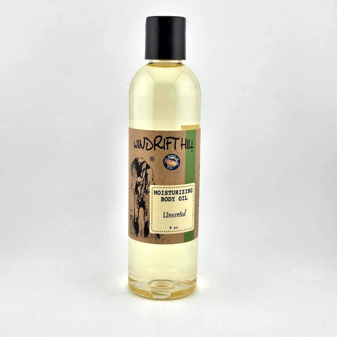 Plastic bottle of Windrift Hill moisturizing body oil on a gray background