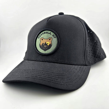 Black baseball cap with a bear patch and text on a white background