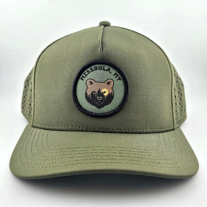 Green cap with bear patch and text on a white background