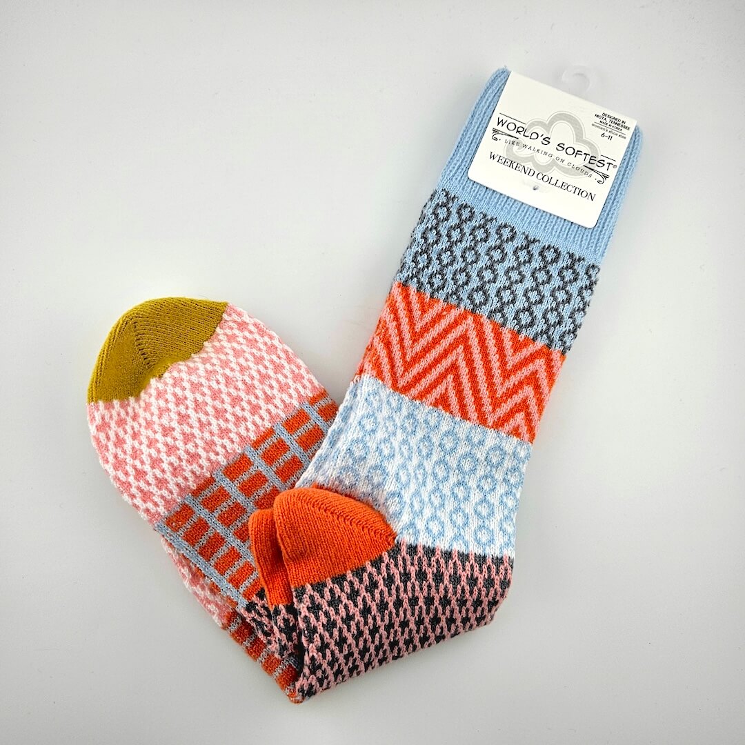 Colorful patterned socks with a brand label on a gray background
