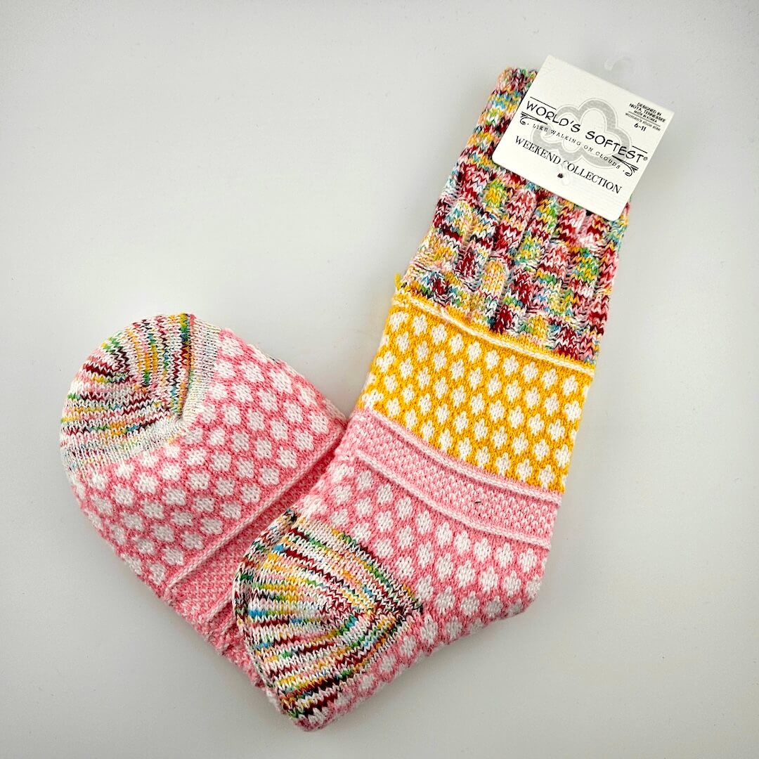 Colorful patterned socks on a gray background with a 'World's Softest' label.