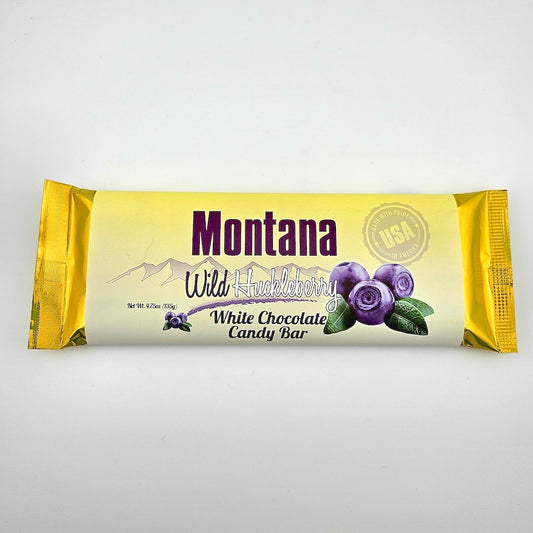 Montana Wild Huckleberry white chocolate candy bar packaging on a light gray background