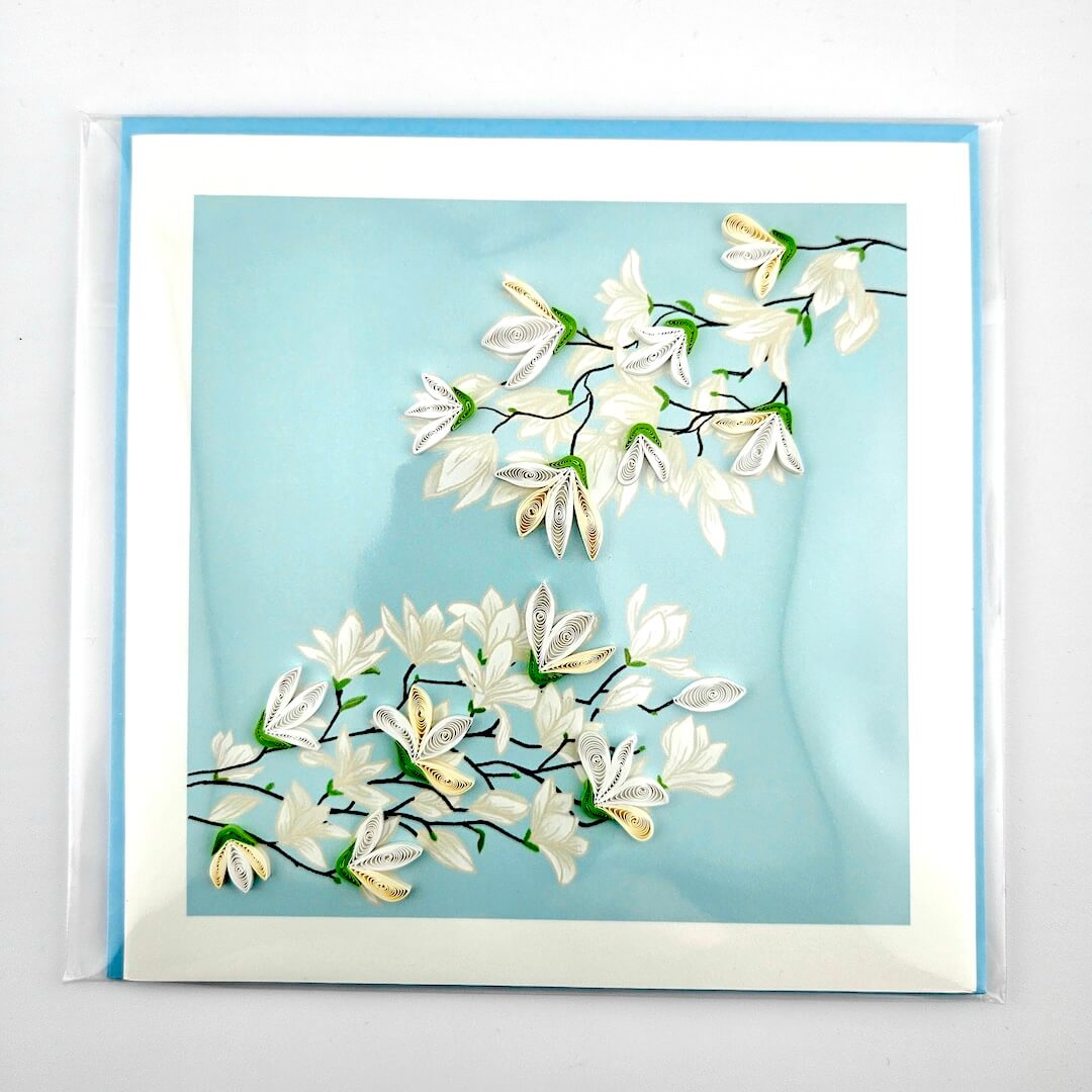 Card with white floral design on a light blue background