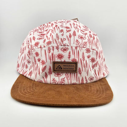 Cap with red floral pattern and brown brim on a light gray background