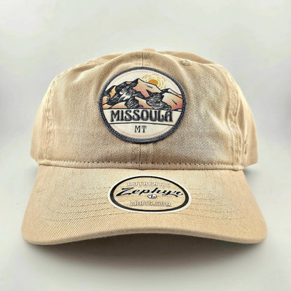 Beige cap with 'Missoula MT' and 'Zephyr' logos on a light gray background