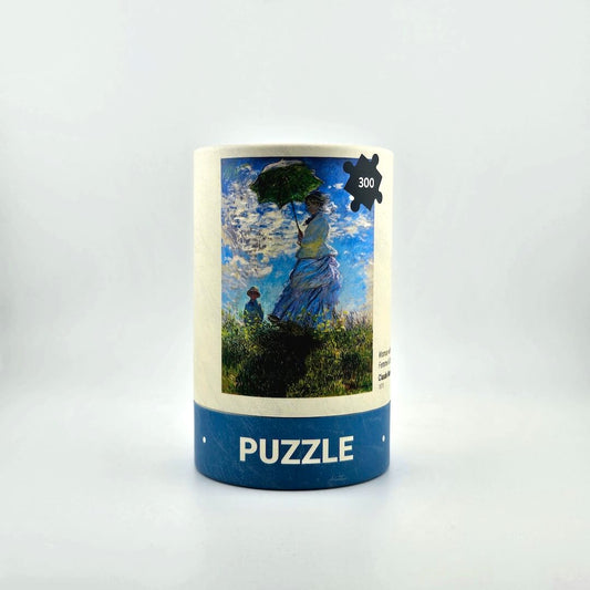 Puzzle box with artwork of a woman with a parasol on a white background