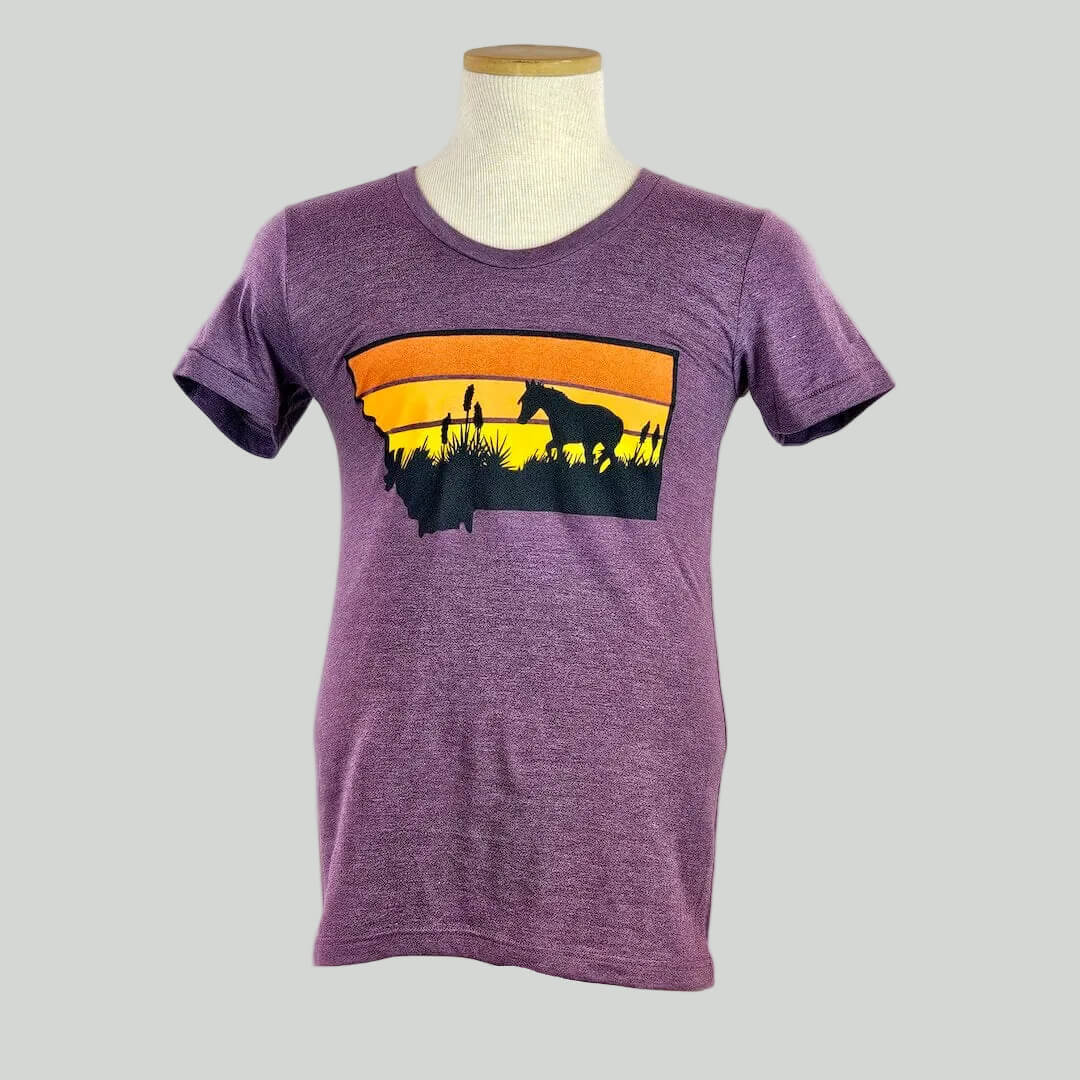 Purple t-shirt with a graphic of two people and a horse on an orange and yellow background, displayed on a mannequin against a white background.