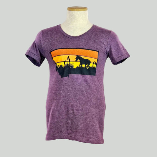 Purple t-shirt with a graphic of two people and a horse on an orange and yellow background, displayed on a mannequin against a white background.