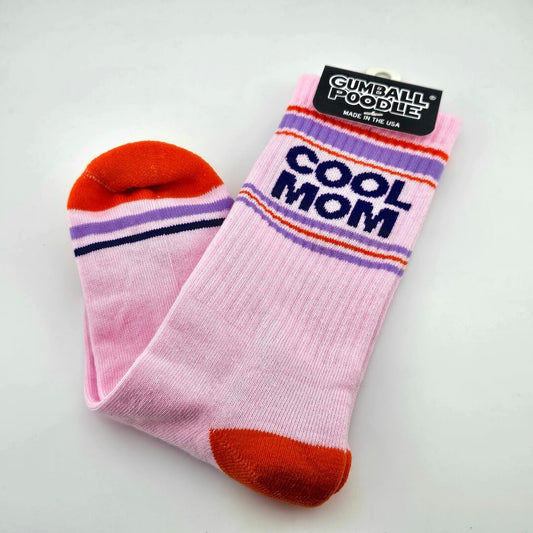 Pink socks with red toes and heels, purple, navy, and red stripes with text, "COOL MOM."