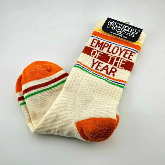 Beige socks with orange heels and toes, maroon and green stripes with text "Employee of the Year."